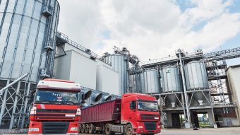 Agricultural Silo - Building Exterior, Storage and drying of grains, wheat, corn, soy, sunflower and two trucks waiting